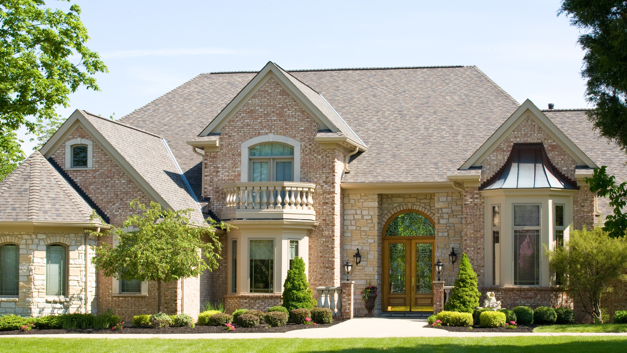 Couple sitting together on couch looking at laptop